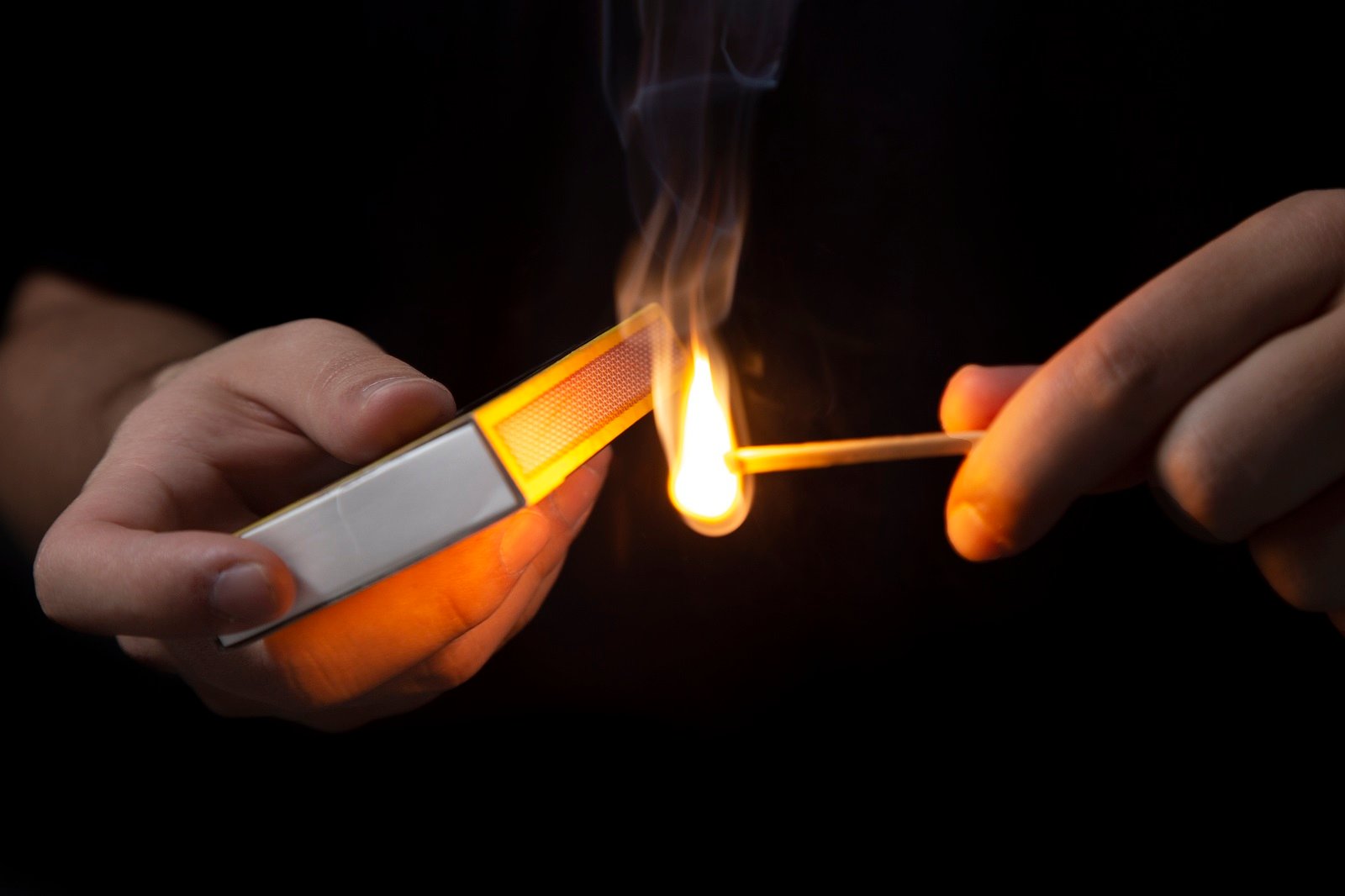 front-view-hands-igniting-match