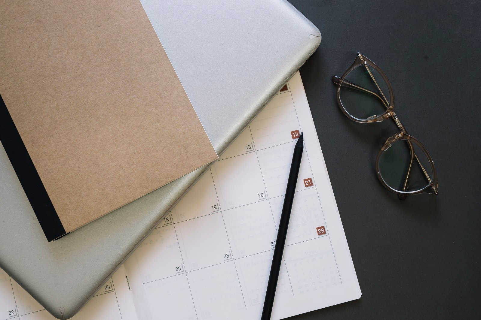 glasses-and-laptop-near-calendar
