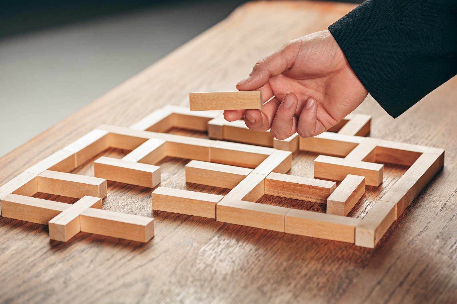 man-and-wooden-cubes-on-table-management-concept