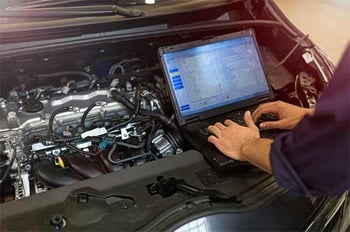 auto-technician-accessing-car-black-box-computer